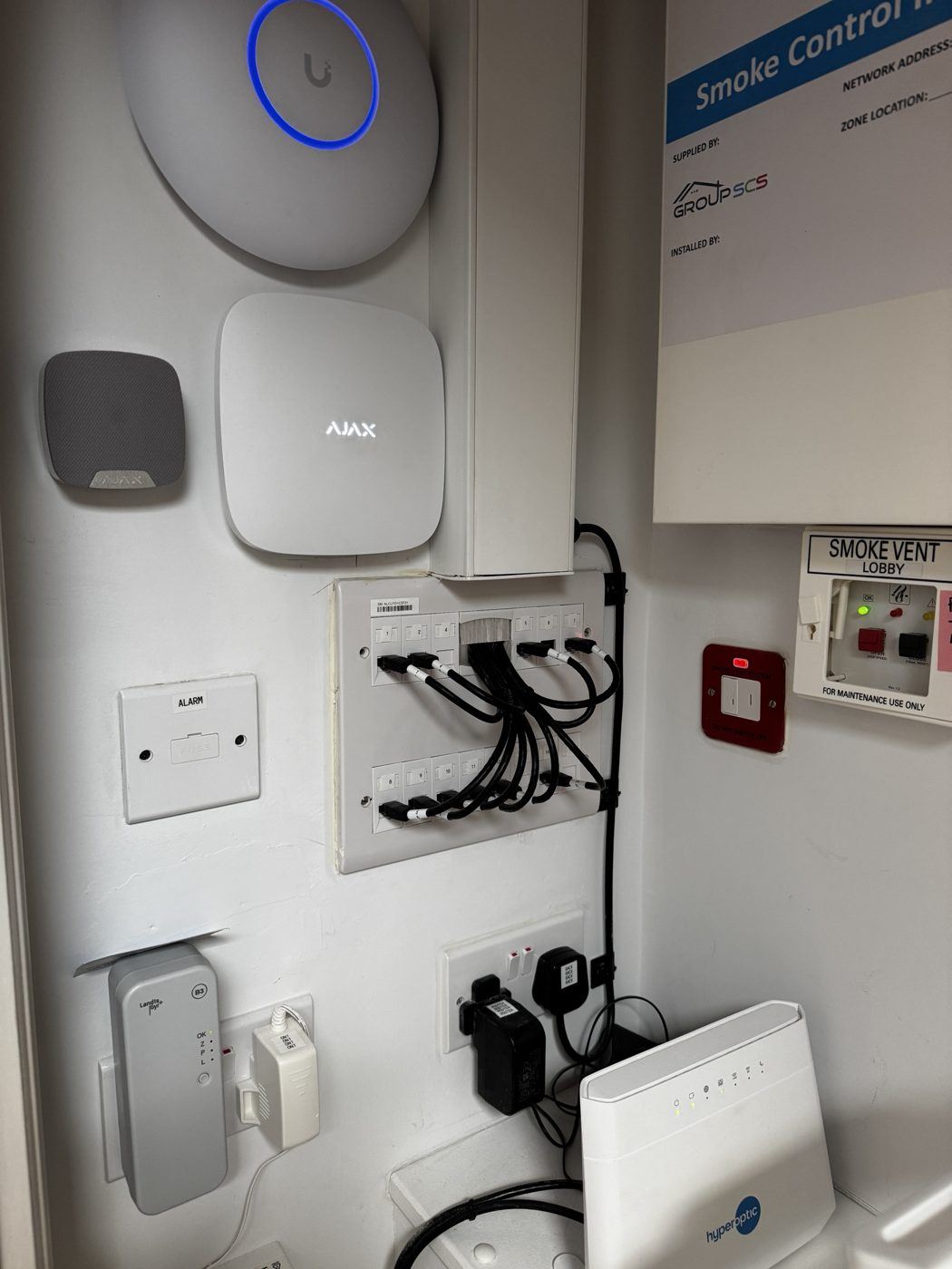 Network, alarm and building systems equipment installed together in a care home comms cupboard