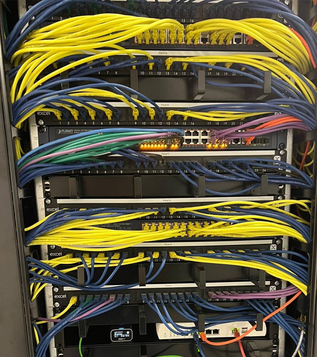 Labelled patch panels, PoE switching and gateway in a care home comms cabinet